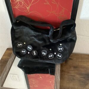 Chic Black Shoulder Bag with Playful Accents